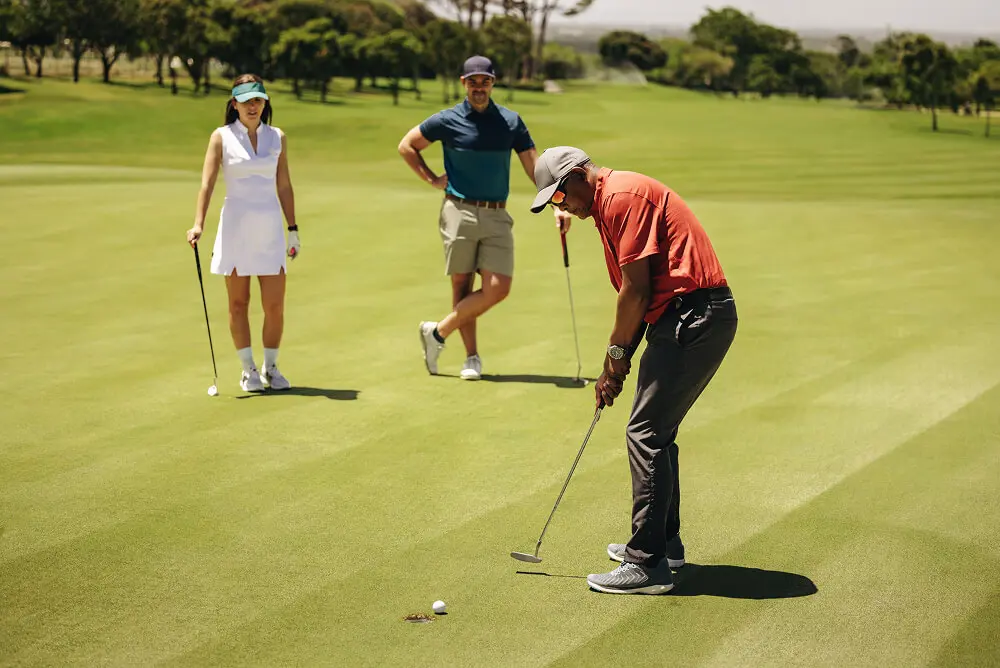 Man focused on putting in golf game