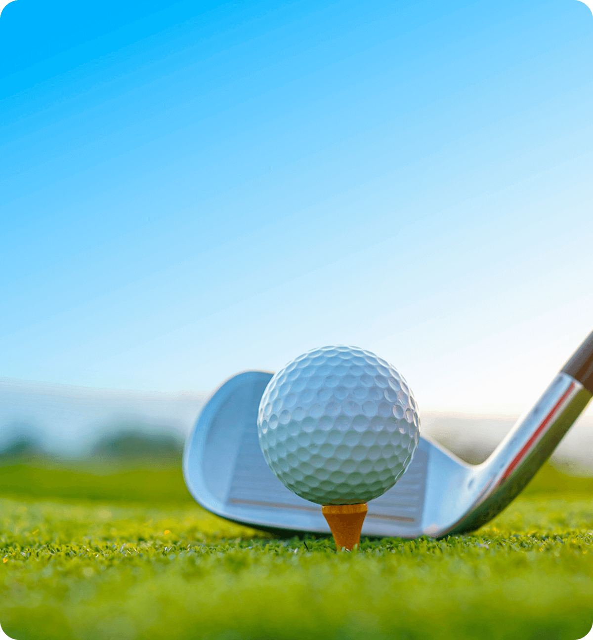 Golf ball on tee with club